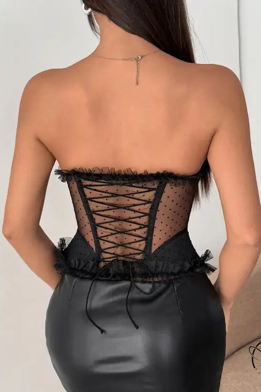 Black strapless polka dot corset dress with lace-up back and ruffled hem