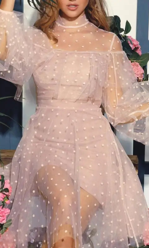 Elegant evening dress in sheer polka dot beige with puffy sleeves