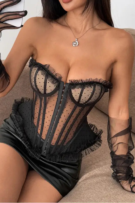 Black lace corset with polka dot boning, ruffled trim, and sheer panels