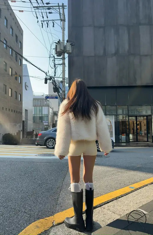 Langry short faux fur coat with black rubber boots and white socks