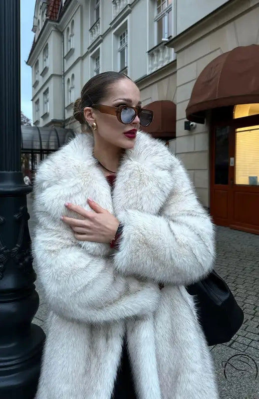 Warm winter faux fur coat with white luxurious texture