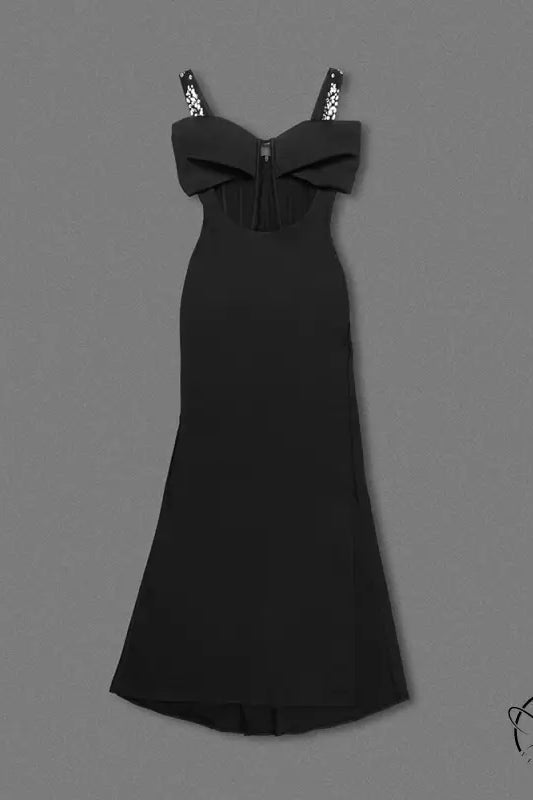 Elegant black maxi dress with spaghetti straps, bow bodice, and rhinestone details