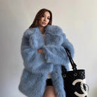 Light blue faux fur coat with Chanel logo tote bag