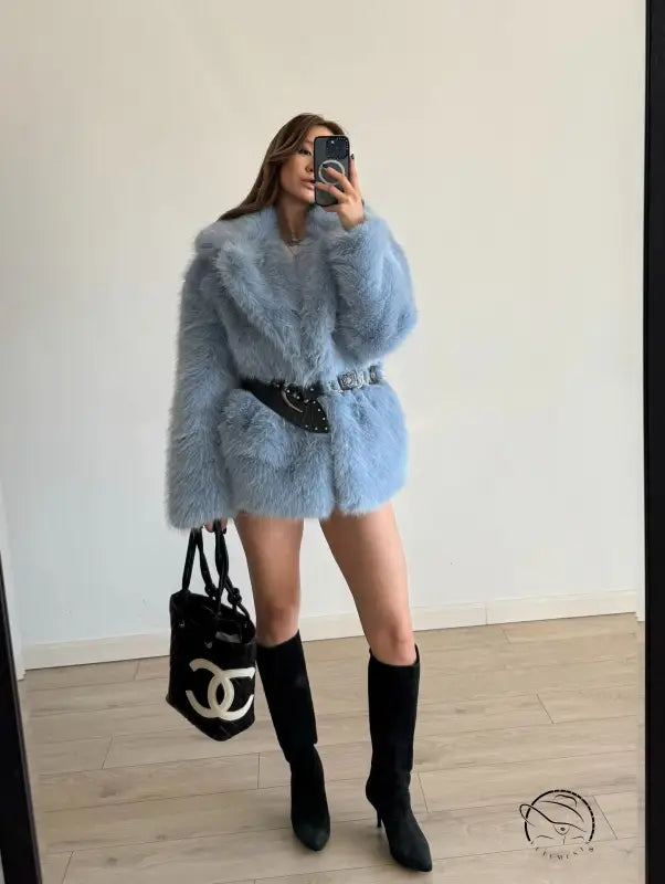 Light blue fluffy faux fur coat with black belt and Chanel bag
