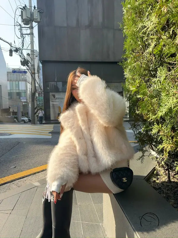 Short loose casual Langry faux fur coat with white fluffy fur, black trim, buttons