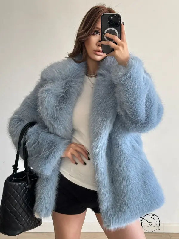 Light blue faux fur coat with quilted black handbag, Langry fashion
