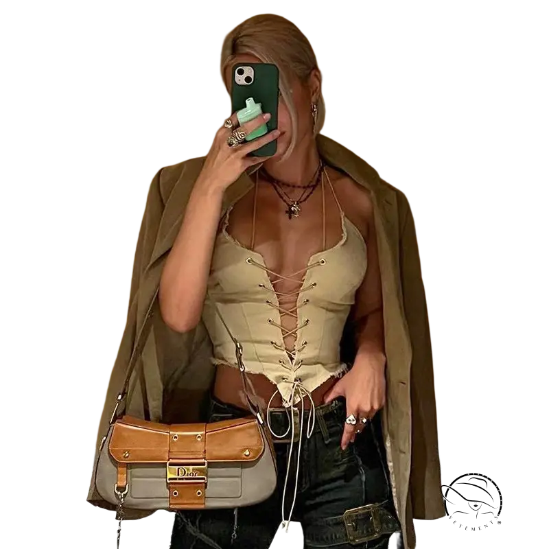 Woman in sexy backless bandage corset taking mirror selfie with handbag